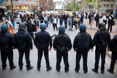 Police stand in a line near protestors after a rally for Freddie Gray, Saturday, April 25, 2015, in Baltimore. Gray died from spinal injuries about a week after he was arrested and transported in a police van. (AP Photo/Patrick Semansky)